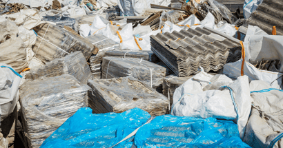 Image shows a landfill with traditional roofing materials.